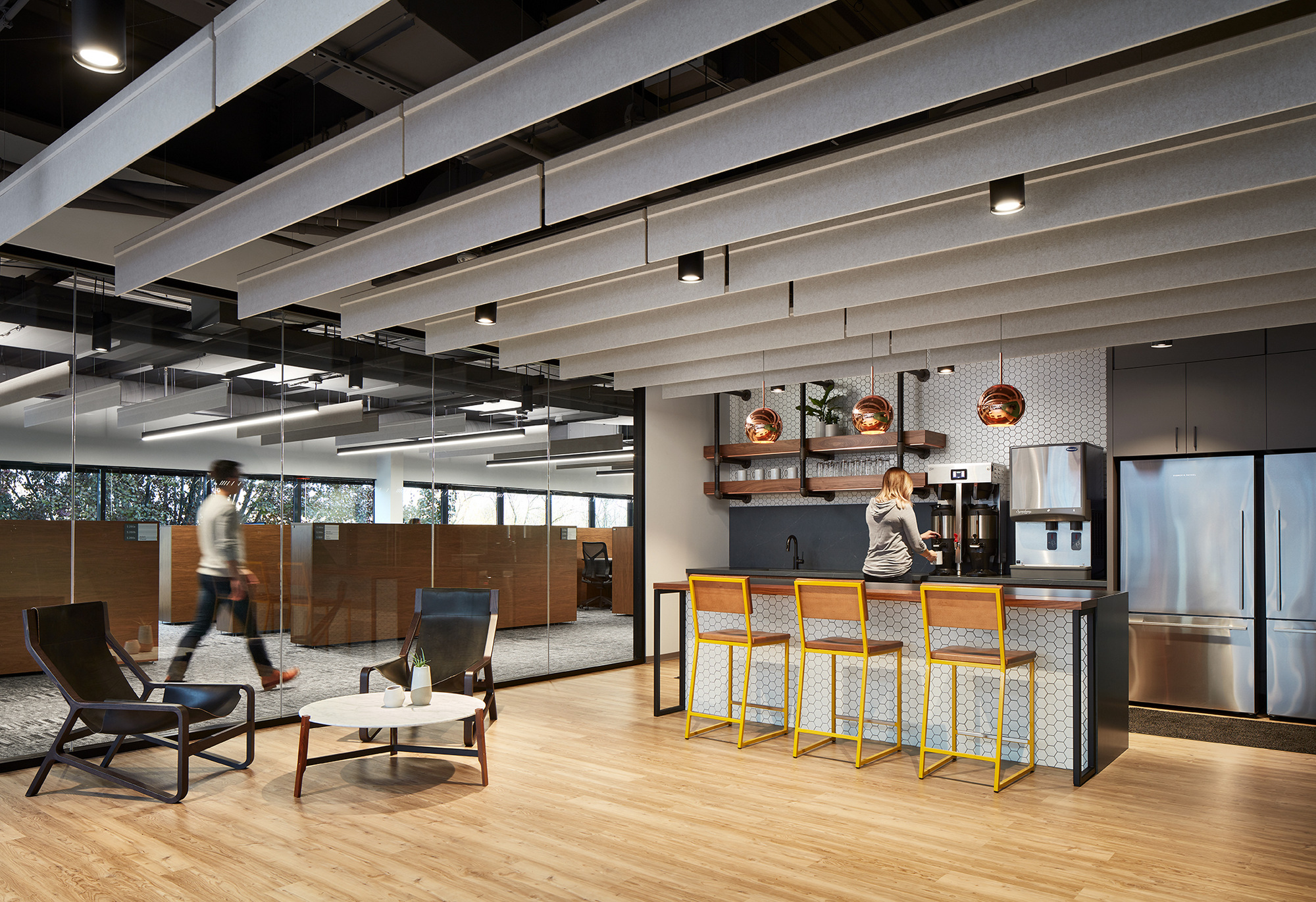 Industrial counter stools inside a modern office break out room. 